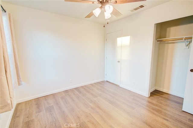 unfurnished bedroom with light wood-style flooring, a closet, visible vents, and baseboards