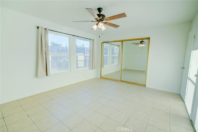 spare room featuring light tile patterned flooring and ceiling fan