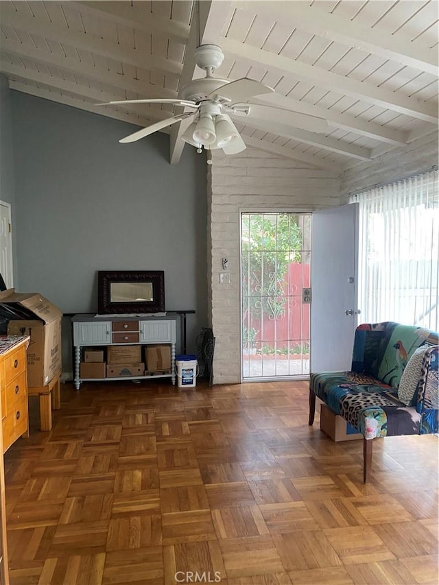 interior space with a ceiling fan and lofted ceiling with beams