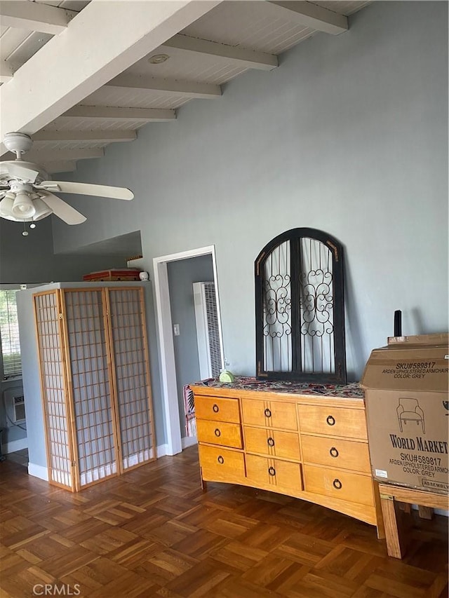 interior space with a ceiling fan, beam ceiling, and a high ceiling