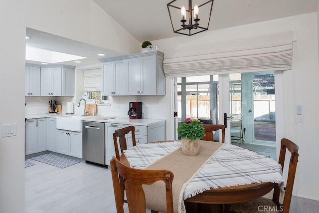 dining space featuring vaulted ceiling, recessed lighting, a notable chandelier, and light wood-style floors