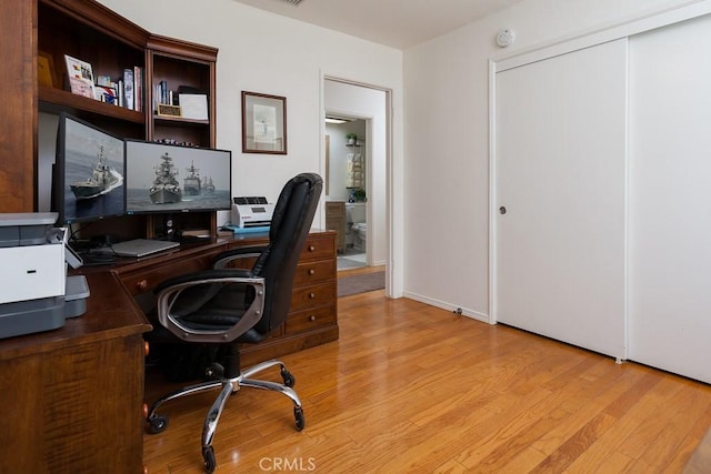 home office with light wood finished floors