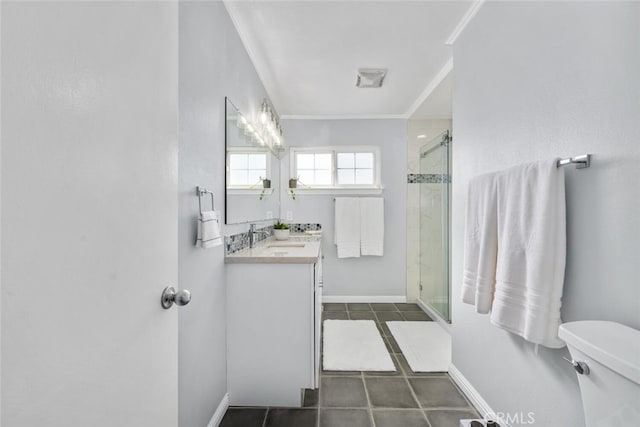 bathroom with tile patterned flooring, toilet, vanity, a shower stall, and crown molding