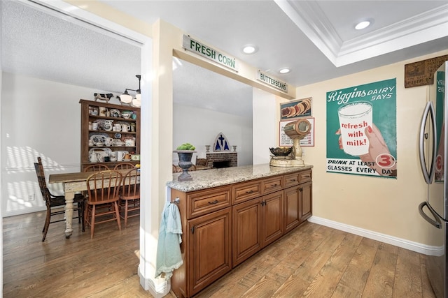 bar with light wood-type flooring, freestanding refrigerator, baseboards, and recessed lighting