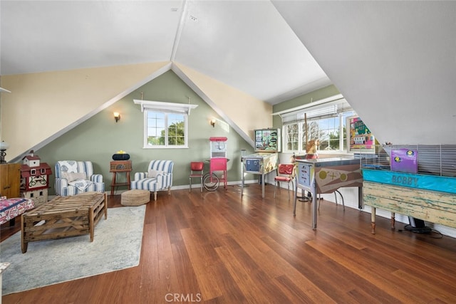 rec room featuring a healthy amount of sunlight, baseboards, wood finished floors, and lofted ceiling