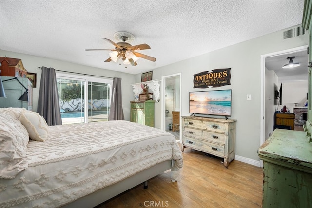 bedroom featuring a textured ceiling, wood finished floors, a ceiling fan, visible vents, and access to exterior