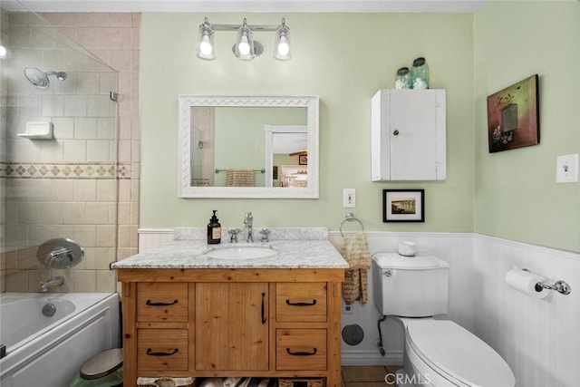 full bath featuring a wainscoted wall, toilet, vanity, and bathing tub / shower combination