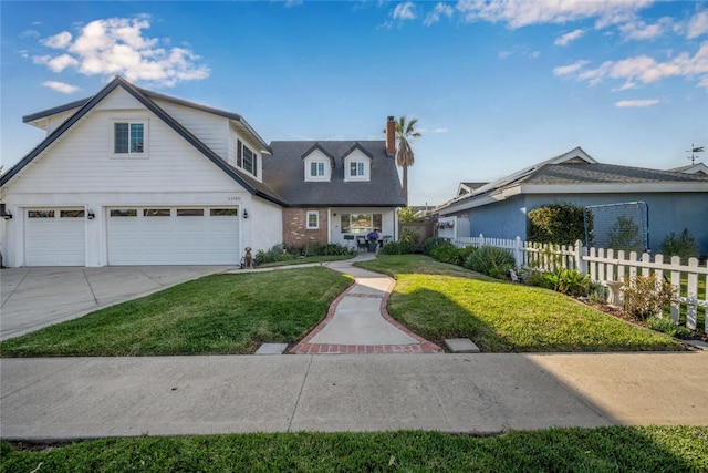 view of front of house with an attached garage, brick siding, fence, driveway, and a front lawn