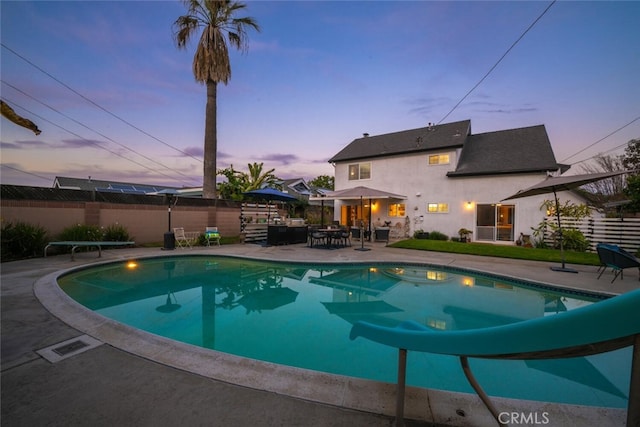 view of swimming pool with a patio area, fence, and a fenced in pool