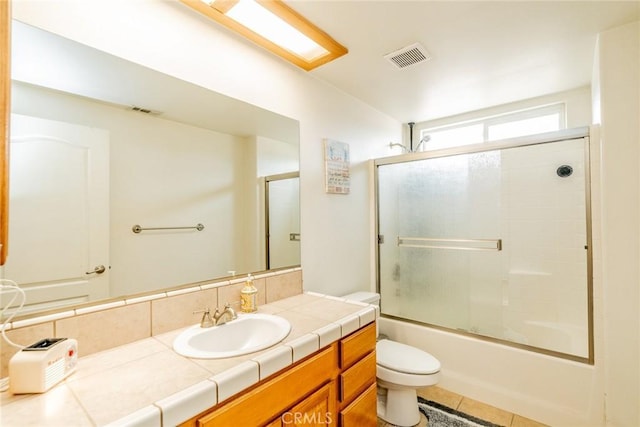 11130 Tenaya Rd, Apple Valley, CA 92308 - bathroom with toilet, vanity, bath / shower combo with glass door, and tile patterned floors