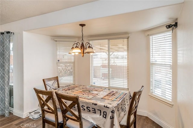 11130 Tenaya Rd, Apple Valley, CA 92308 - dining area with a chandelier, wood finished floors, baseboards, and healthy amount of natural light