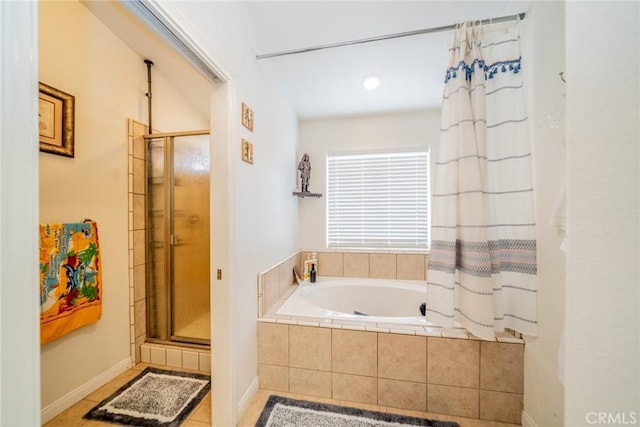 full bathroom with a shower stall, tile patterned floors, and tiled bath