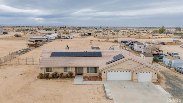 11130 Tenaya Rd, Apple Valley, CA 92308 - view of front of property with concrete driveway, roof mounted solar panels, a garage, and a tile roof