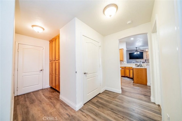 11130 Tenaya Rd, Apple Valley, CA 92308 - corridor with wood finished floors, baseboards, and arched walkways