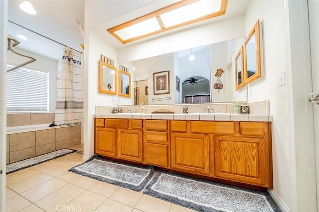 11130 Tenaya Rd, Apple Valley, CA 92308 - bathroom with double vanity, tile patterned floors, and tiled bath
