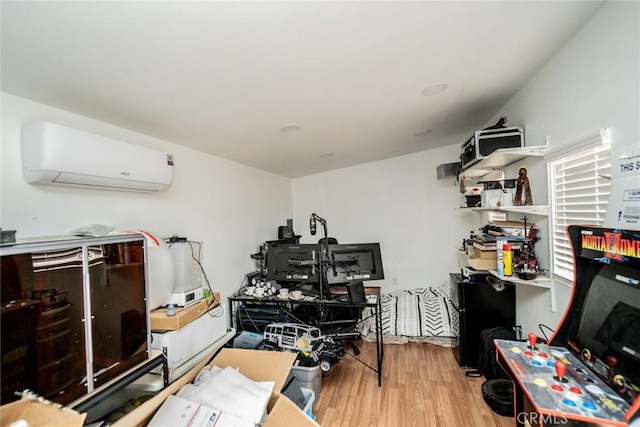 home office featuring wood finished floors and a wall mounted AC