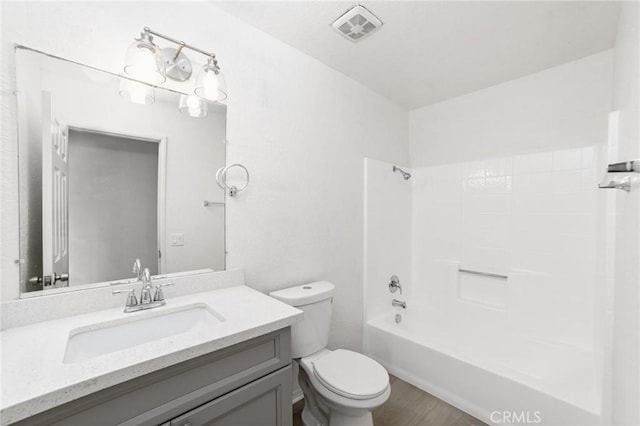 bathroom with toilet, shower / bath combination, vanity, and visible vents