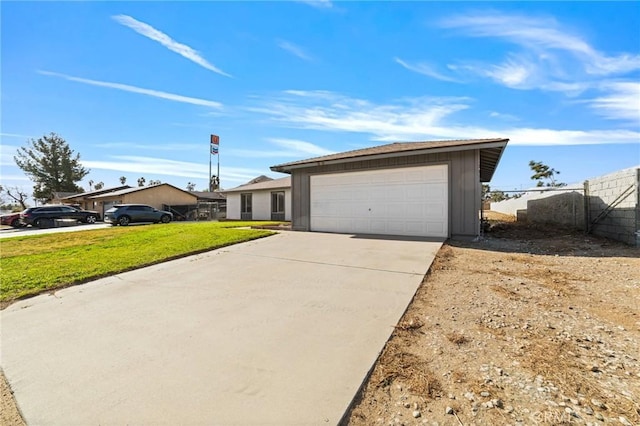 view of front of property with driveway, a garage, fence, and a front yard