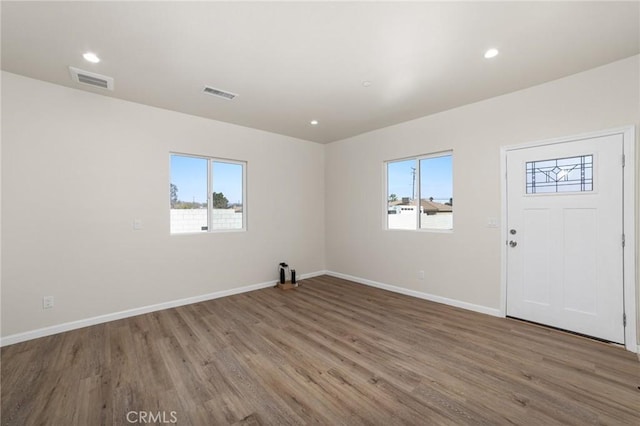 interior space with recessed lighting, visible vents, baseboards, and wood finished floors