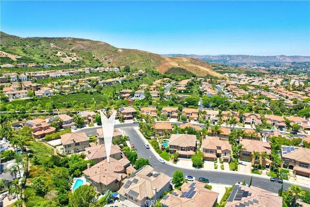 drone / aerial view featuring a residential view and a mountain view