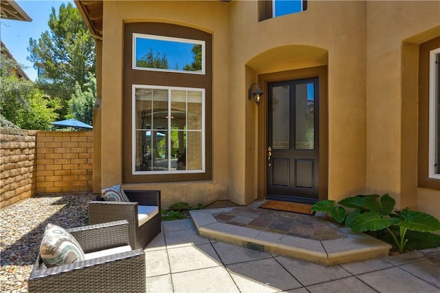 doorway to property with a patio and stucco siding