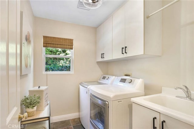 laundry room with cabinet space, visible vents, baseboards, washing machine and dryer, and a sink