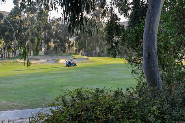 surrounding community with a lawn and golf course view