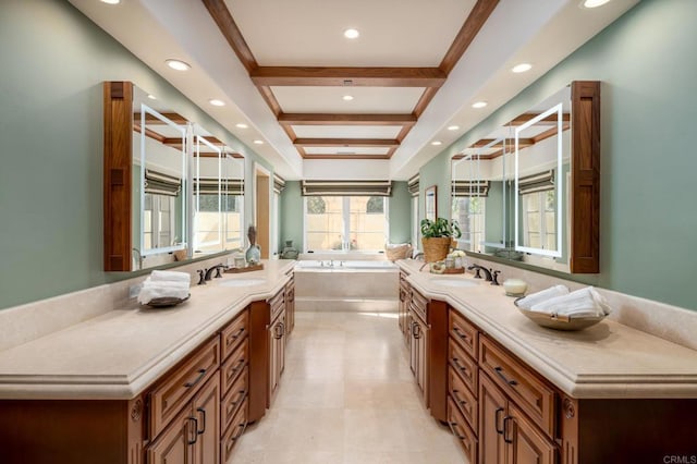 bathroom with a garden tub, vanity, and recessed lighting