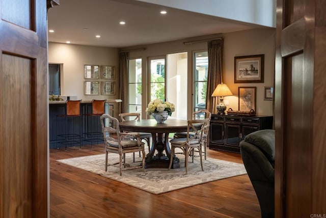 dining area with recessed lighting and wood finished floors