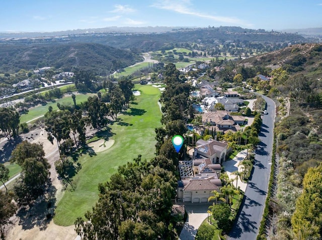 drone / aerial view with a mountain view, a residential view, and view of golf course