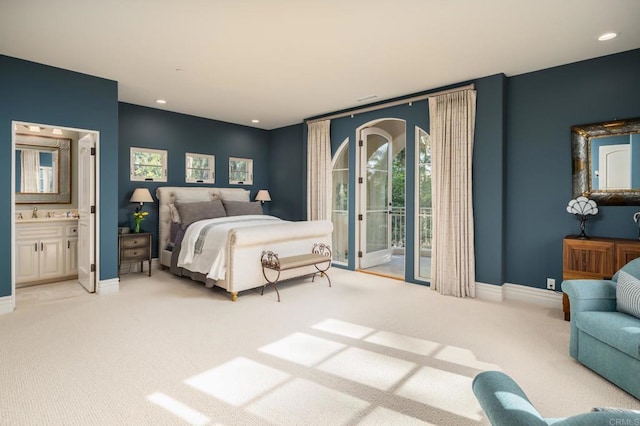 bedroom featuring access to exterior, baseboards, light carpet, and connected bathroom