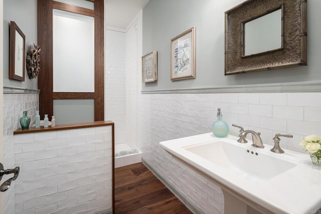 14479 Emerald Ln, Rancho Santa Fe, CA 92067 - bathroom featuring tile walls, a stall shower, wood finished floors, a sink, and wainscoting
