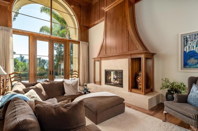 14479 Emerald Ln, Rancho Santa Fe, CA 92067 - living room featuring french doors, a towering ceiling, wood finished floors, and a premium fireplace