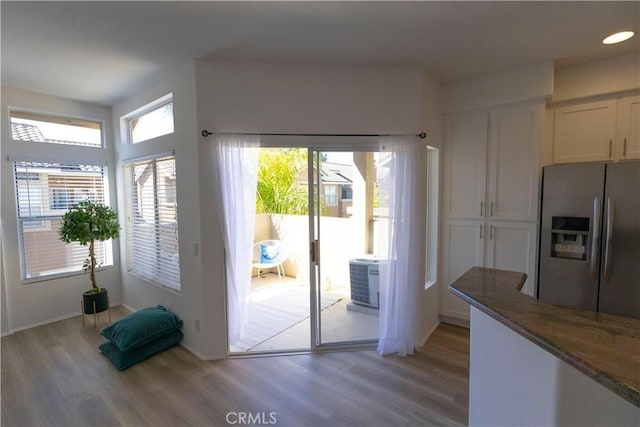 doorway to outside featuring light wood-style floors, recessed lighting, and baseboards