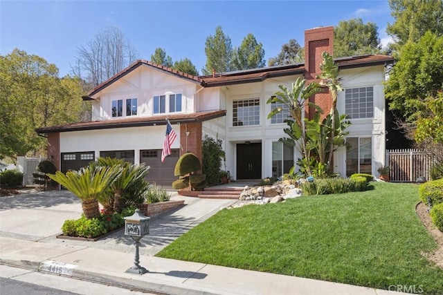 mediterranean / spanish-style home featuring a front lawn, fence, stucco siding, a garage, and driveway