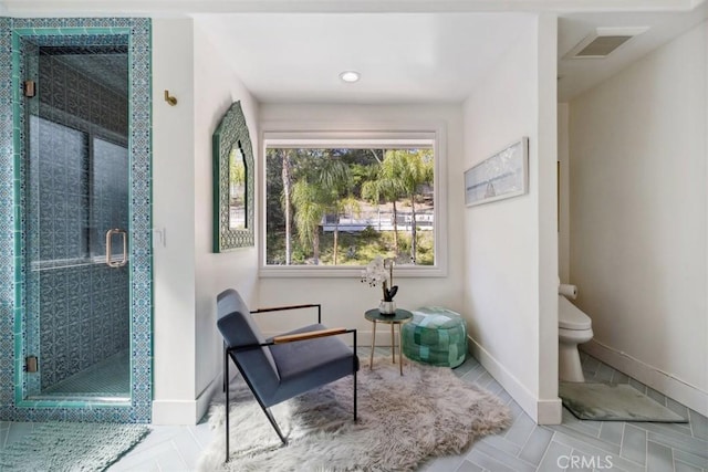 living area featuring recessed lighting, tile patterned floors, visible vents, and baseboards