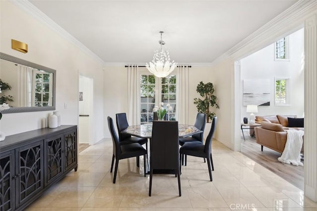 dining space featuring a chandelier, crown molding, baseboards, and light tile patterned floors