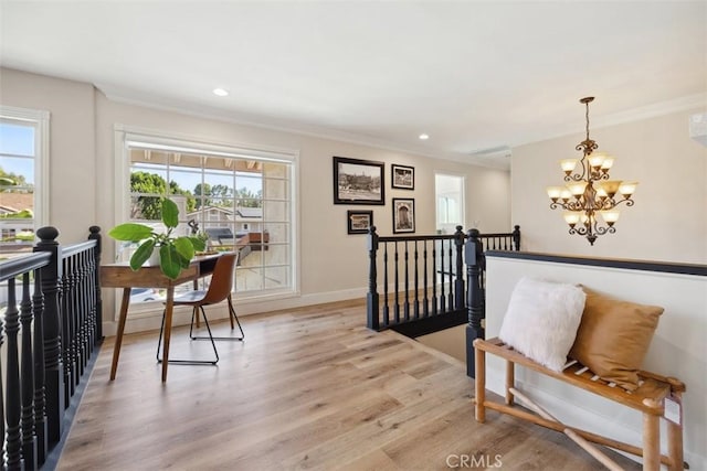 sitting room with a notable chandelier, recessed lighting, light wood-style floors, an upstairs landing, and baseboards