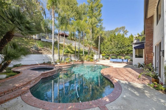 view of swimming pool with an in ground hot tub, a patio, fence, and a fenced in pool