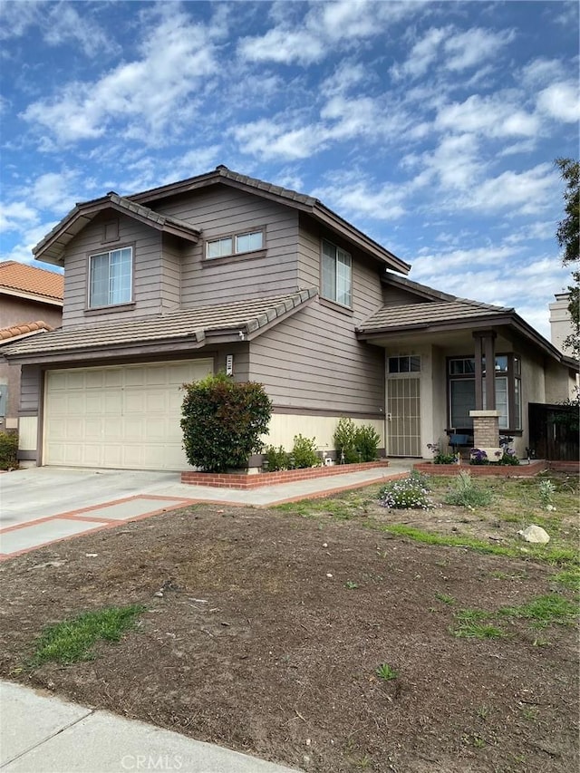 view of front facade with a garage and concrete driveway