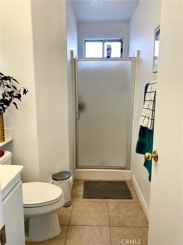 full bathroom featuring toilet, a stall shower, vanity, a textured ceiling, and tile patterned flooring