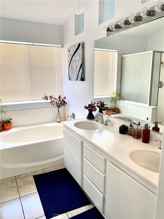 bathroom featuring tile patterned flooring, a sink, a bath, and a shower stall