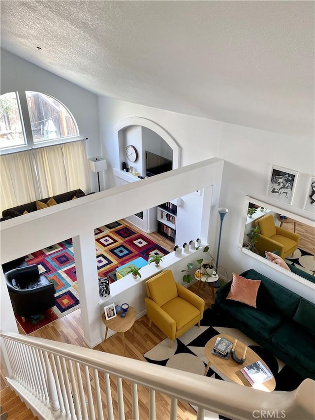 living area with a textured ceiling and wood finished floors