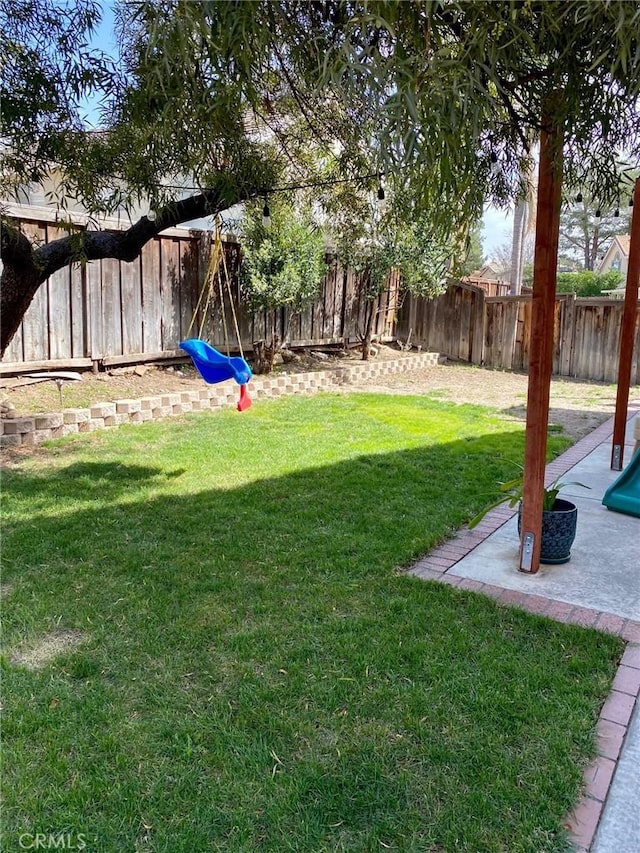 view of yard with a fenced backyard and a patio