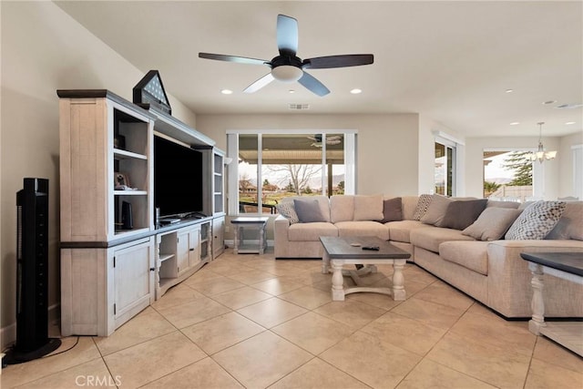 living room featuring recessed lighting, ceiling fan with notable chandelier, visible vents, and light tile patterned flooring