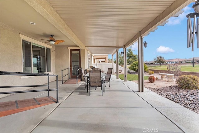 view of patio / terrace featuring ceiling fan, outdoor dining area, and fence