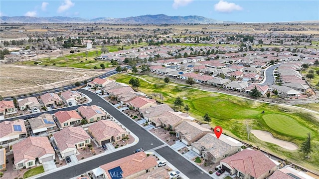 bird's eye view with a mountain view, view of golf course, and a residential view