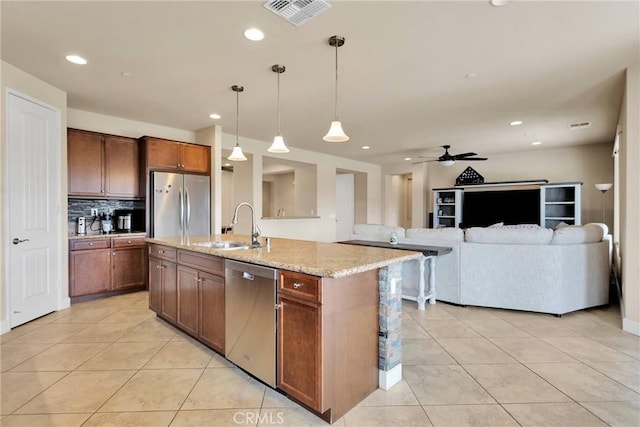 kitchen with light stone counters, light tile patterned floors, visible vents, appliances with stainless steel finishes, and a sink