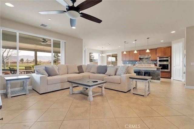 living area with recessed lighting, a healthy amount of sunlight, visible vents, and light tile patterned floors