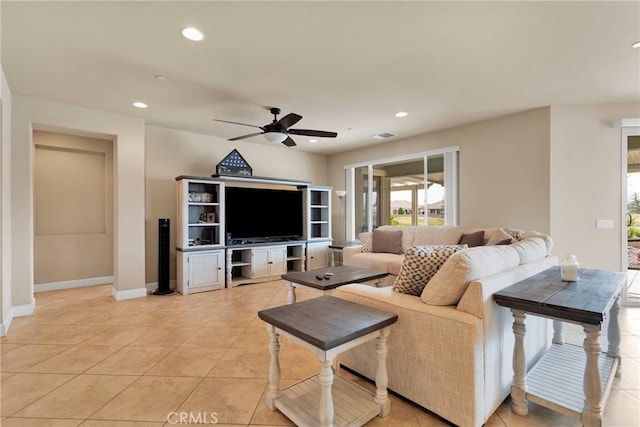 living area featuring light tile patterned floors, baseboards, a ceiling fan, and recessed lighting